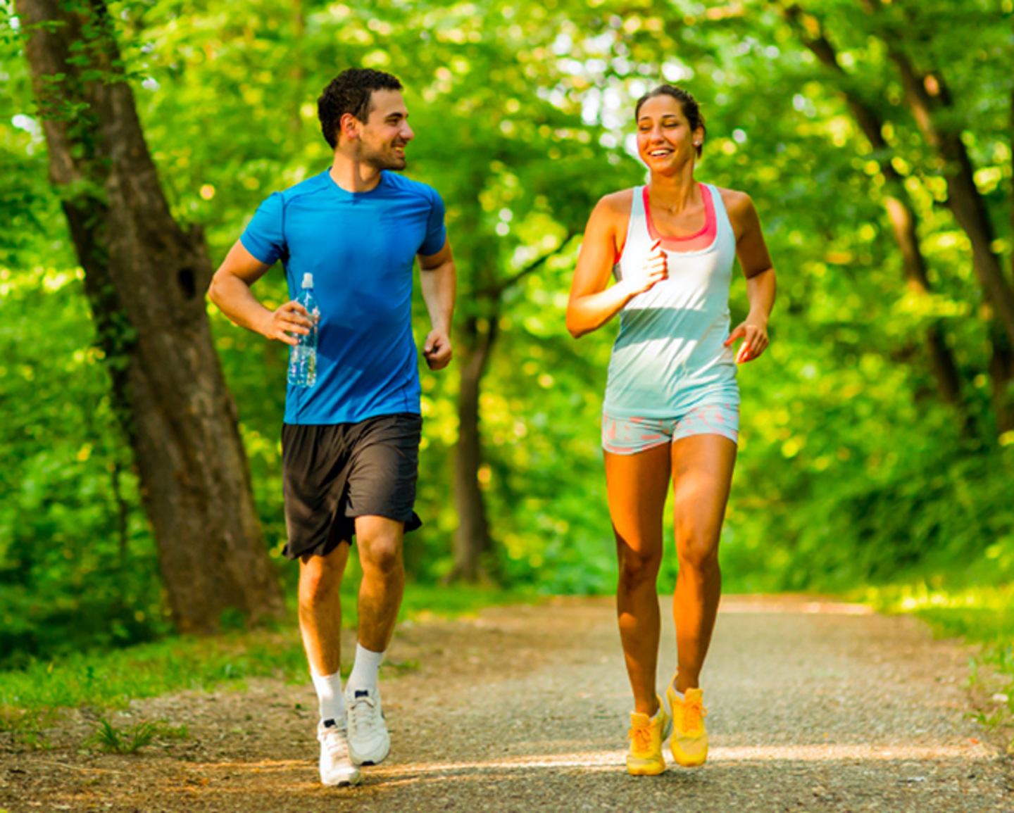 Pareja de personas trotando en la naturaleza